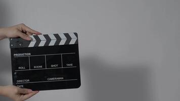 hand holding empty film slate. and clapping in front of camera video