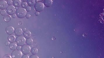 Oil bubbles movement abstract background. A motion of clear oil bubbles floating in colors liquid. Relaxing and artistic visual experience background. symbolizing fluidity science from oils and water. video