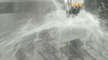 Demo of CNC milling machine cutting the steel parts with water coolant method. video