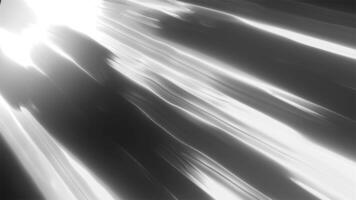 Abstract black and white light streaks moving diagonally, creating a futuristic and dynamic visual effect background video
