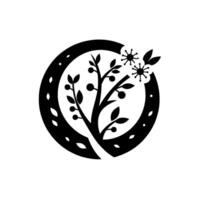 A stylized black and white illustration of a tree, fruit, and flowers enclosed in a circular frame with decorative cutouts, embodying simplicity and elegance. vector