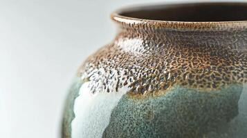A close up of a vase with brown and green glaze photo