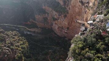 Aerial view of rope swing setup over a canyon with rugged cliffs video