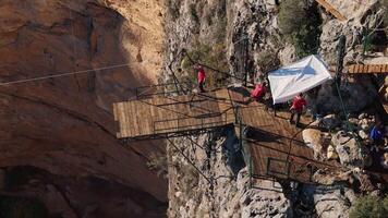 Aerial rope swing jump from a cliff platform into a deep canyon video