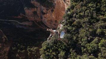 Adventure seekers on canyon platform preparing for jump video
