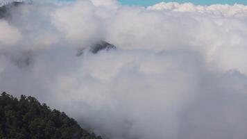 Aerial. The sky is filled with clouds and the mountains with trees. Lombok video