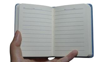 Open notebook held by hand ready for notes, isolated on white background displaying lined pages for writing or drawing photo