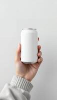Hand holding a white aluminum soda can, providing a clean and minimalist aesthetic with a transparent background design element. photo