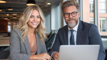 Businessman and businessledy at a laptop in a modern office. Confidence, success and productivity at work. Business communications, strategy discussion and cooperation in a corporate environment photo