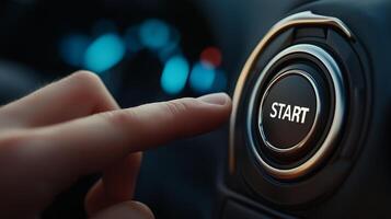 A person is pressing the start button on a car photo