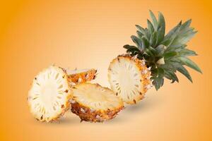 Pineapple slices isolated on an orange background photo