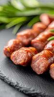 A tasty plate of sausages accompanied by fresh green onions for a flavorful and satisfying culinary experience photo