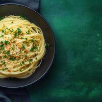 Traditional plate of spaghetti with fresh parsley and olive oil served on a rustic table ready for dinner photo