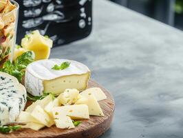 Elegant cheese platter accompanied by a glass of fine wine photo