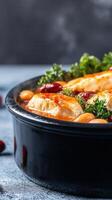 A generous bowl of tender chicken accompanied by a colorful array of fresh vegetables on a rustic table setting photo