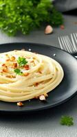 Classic plate of pasta with fresh parsley and olive oil served on a beautifully set dining table ready to enjoy photo
