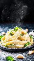 Flavorful plate of pasta with garlic and fresh parsley served elegantly on a white tablecloth with utensils photo