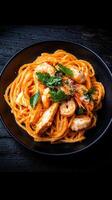 Exquisite plate of pasta topped with succulent shrimp and garnished for a delicious and satisfying culinary experience photo