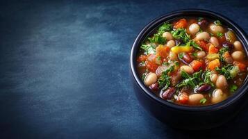 A flavorful bowl of hearty soup packed with nutritious beans and vibrant vegetables for a filling meal photo