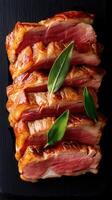 Artfully plated meat dish garnished with a single leaf on top for an elegant presentation and culinary delight photo