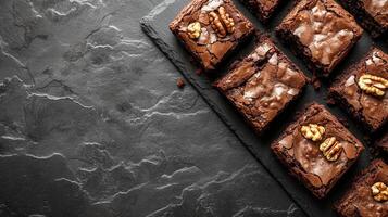 Rich and fudgy brownies topped with crunchy nuts and melted chocolate for a decadent dessert experience photo