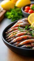 A flavorful plate of grilled fish accompanied by fresh lemons and tomatoes arranged artfully for a delicious meal photo