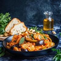 A bowl of tasty food accompanied by freshly baked bread on a wooden table, perfect for a hearty and fulfilling meal photo
