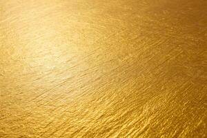 Golden surface with intricate texture and warm metallic shine, abstract shiny background with rich golden tones photo