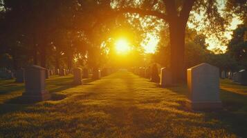 Cemetery with sun light. Many tombstones on green grass. Sunlight passing through trees. Quiet and peaceful place at sunset. photo