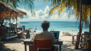 Freelancer Man works on laptop. Ocean beach view. Relaxing vacation on tropical island. Remote job with calm waters. Summer work from paradise. photo