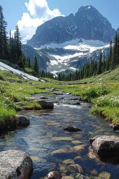 Mountain view. Clear water flows. Stream goes downhill. Green grass grows around. Blue sky above. Rocks are in water. photo