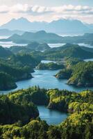 Island view from above. Green trees cover islands with water in between. Mountains rise in background under cloudy sky. photo
