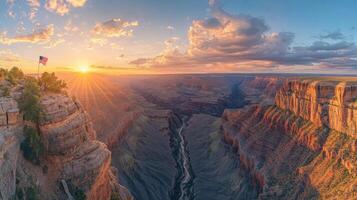 Grand canyon view at sunset. Cliffs and valley landscape. Sky with clouds and sun shining. Nature scene with flag on rock. photo