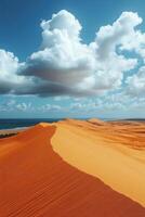 Sand dunes meet ocean. Blue sky with white clouds above desert. Sands near water. Dunescape landscape view. Coastal sand dunes in sunshine. photo