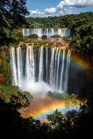Waterfall cascade view. Falling water with rainbow. Green plants and trees around. Nature landscape scene. Beautiful sky in the background. Scenic travel destination. photo
