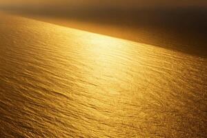 Elegant golden glow with subtle textured pattern, warm metallic sheen on smooth surface, abstract gold background photo
