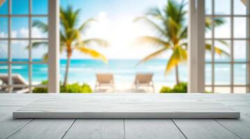 White table top on wooden table in front of a window with a view of the beach photo