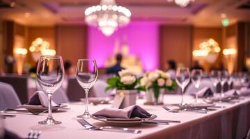 A table set for a wedding reception with purple lighting photo
