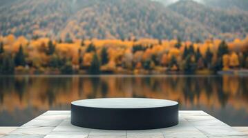 An empty round table in front of a lake and trees photo
