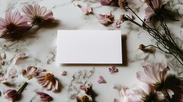 Blank card on marble background with flowers photo