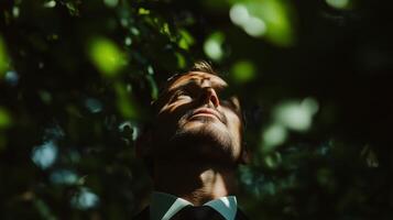 A man in a suit and tie looking up at the sky photo