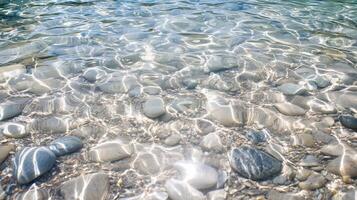 A clear body of water with rocks and pebbles photo