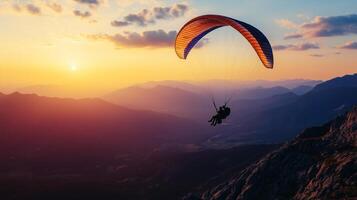 Beautiful paragliding over the mountains at sunset photo