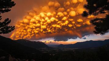 A rainbow is seen over a mountain range photo