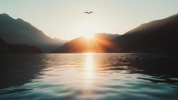 A bird flying over a lake with mountains in the background photo