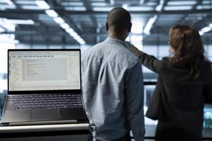 Focus on lines of code on laptop screen used by data center engineers in blurry background to execute security patches. Close up of script on notebook ran by server hub employees scanning equipment photo