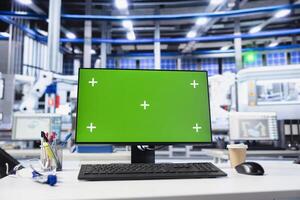 Chroma key mockup PC monitor in photovoltaics factory used for analyzing data and reviewing system metrics. Green screen computer in solar panels plant troubleshooting technical issues photo