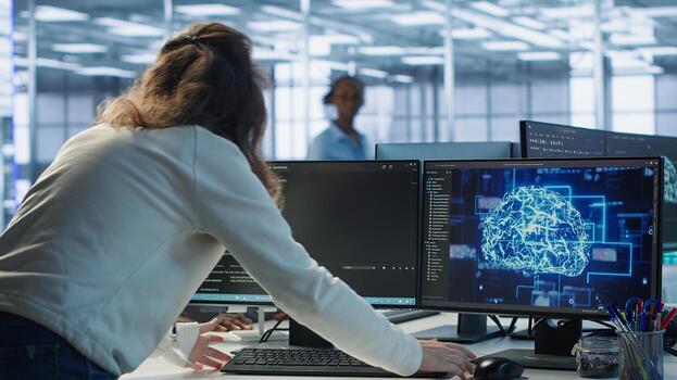 Admin panicking after computer crash affecting server room AI workloads, spamming keyboard keys. Artificial intelligence employee struggling to repair data center systems after network failure, camera A photo