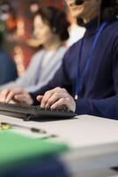 Call center staff member handling customer inquiries, complaints and support requests in office. Close up of customer service operator assisting customers with issues related to products or services photo