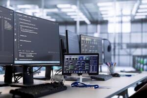 Computers in data center hosting rackmount ensuring faultless operations conditions. Close up of PC monitors and tablet on desk used for monitoring data center devices energy consumption photo